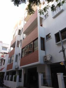 a white building with a red roof at The Briggo Service Aparment in Pondicherry