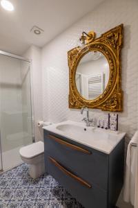 a bathroom with a sink and a toilet and a mirror at Aniana Alojamiento Boutique in Logroño +45 photos