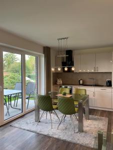 a kitchen and dining room with a table and chairs at Dahmer Strand W 14 in Dahme