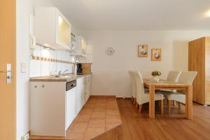 a kitchen and dining room with a table at Yachthafenresidenz-Wohnung-8204-852 in Kühlungsborn