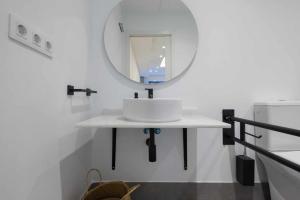 a bathroom with a white sink and a mirror at AT Presidente Nº3 apartamento privado completo in Seville