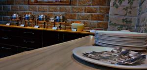 a table with plates and utensils on a counter at Peaceful & scenic Homestay in Shoghi-Shimla in Shimla