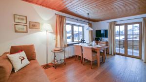 a living room with a couch and a table at Chalet Wohnung Wilder Kaiser in Kitzbühel