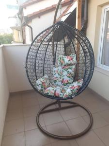 a hanging chair with pillows on a balcony at Cosy Charming 2-Bed Apartment in Blagoevgrad in Blagoevgrad