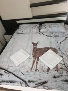 a bed with a picture of a deer on it at Luxury Two Bedroom Flat in Blagoevgrad