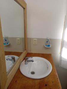 a bathroom with a white sink and a mirror at CAMPO SANTO in Comunidad Yumani