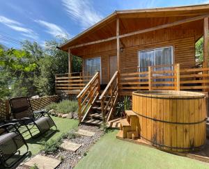 a wooden cabin with a hot tub in the yard at Cabañas del Maipo in San José de Maipo