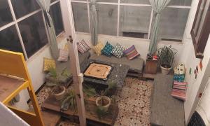 an aerial view of a balcony with a couch and plants at Raahi Backpacker's Hostel in Udaipur