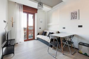 a living room with a couch and a table at Milano Renovated Studio APTS in Milan