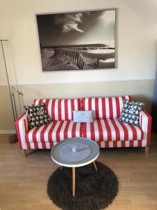 a living room with a red couch and a table at Villa Baltica Wohnung 02 in Dahme