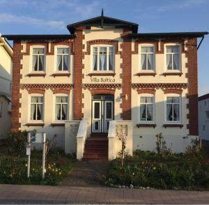 a brick building with a sign that reads wine ballater at Villa Baltica Wohnung 02 in Dahme