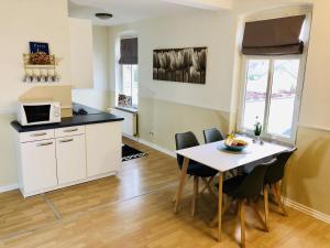 a kitchen and dining room with a table and chairs at Villa Baltica Wohnung 02 in Dahme