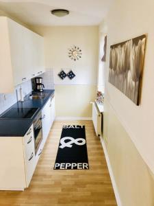 a kitchen with a black and white rug on the floor at Villa Baltica Wohnung 02 in Dahme