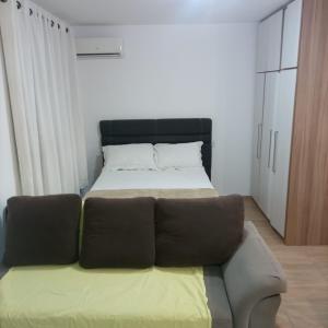 a bed and a couch in a room at Residencial Dona Preta in Florianópolis