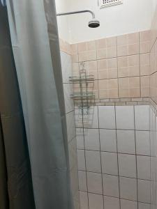 a bathroom with a shower with a shower head at The Cottage on Roy Wright in Umkomaas
