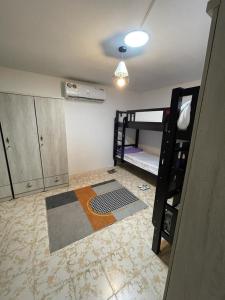 a room with two bunk beds and a ceiling at Roxy Hostel in Abu Dhabi