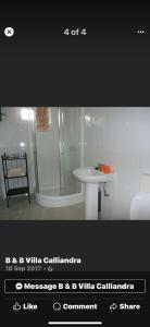 a bathroom with a shower and a white sink at B & B Villa Calliandra in Bijilo