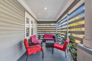 a balcony with red chairs and a table at Charlotte Luxury Home NoDa in Charlotte