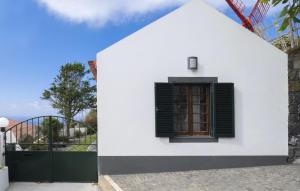 a white house with a window and a gate at WelcomeBuddy - Casa do Moinho Garden & Sea Retreat in Ponta Delgada
