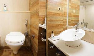 a bathroom with a toilet and a sink at FabHotel Prime Deccan 8 in Pune