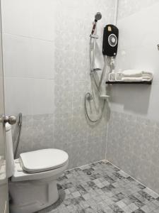 a bathroom with a shower and a toilet in it at Pk house and cosy in Betong