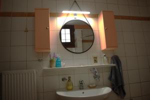 a bathroom with a sink and a mirror at YourLittleMiracle-PanoramicView+FirePit+Garden+BBQ in Argalasti