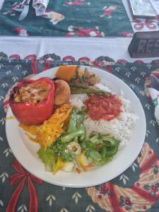 a plate of food with rice and vegetables on a table at Thumbi View Lodge in Cape Maclear