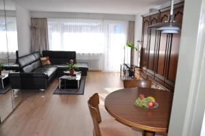 a living room with a table and a couch at Haus Viktoria A in Zermatt