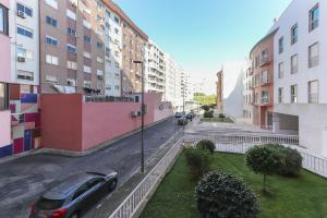 a car parked on a street next to buildings at Laranjeiras Deluxe by Homing in Lisbon