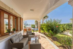 an outdoor patio with couches and a table at Chalet Cladera Socias in Port d'Alcudia