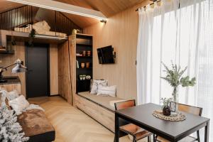 a living room with a couch and a table at Luxe Tiny House op minicamping in Waarde in Waarde