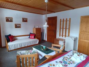 a living room with a bed and a table at Privát Majo - Váš oddych na Liptove in Liptovský Mikuláš