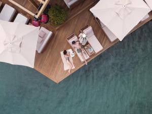 an overhead view of a hotel room with a woman sitting on a table at No81 Hotel in Golturkbuku