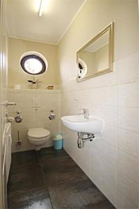 a bathroom with a sink and a toilet at Urlaubstraeume-am-Meer-Wohnung-3-11-641 in Kühlungsborn