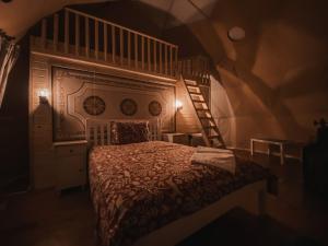 a bedroom with a bed and a spiral staircase at Cucu Zen Dome Cabana Cazare Bucovina 