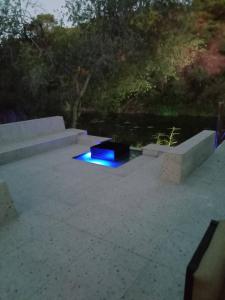 a stage with a blue light on a patio at Mologa River Lodge in Rust de Winter