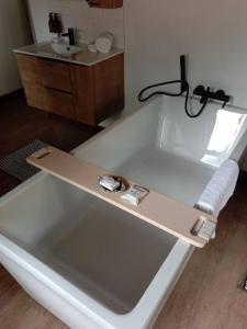 a large white bath tub with a belt on it at Mologa River Lodge in Rust de Winter