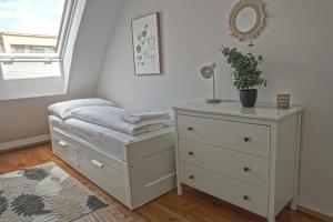 a bedroom with a bed and a dresser at Newly renovated 3 bedroom Apartment with AC and bath tub in Vienna