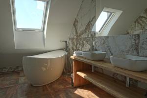 a bathroom with two sinks and a large mirror at Newly renovated 3 bedroom Apartment with AC and bath tub in Vienna