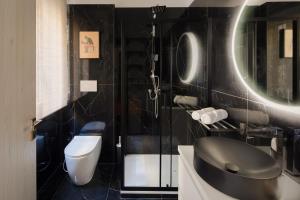 a bathroom with a toilet and a sink at Pop Corn Vatican Suites in Rome +12 photos