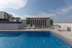 a swimming pool on the roof of a building at Spacious 3BR Apartment Near Miracle Garden in Dubai