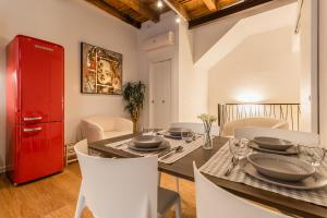 a dining room with a red cabinet and a table at Veronetta The Cellar in Verona