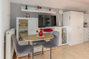 a small dining room with a table and chairs at Oddih ob Krki in Škocjan +21 photos