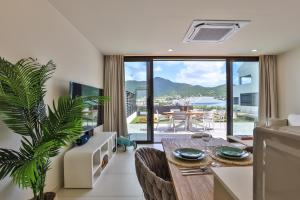 a living room with a table and a couch at The Hills Residence in Simpson Bay