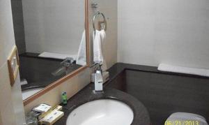 a bathroom with a sink and a mirror at FabHotel Prime Orchard Hospitality in Pune