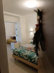 a bedroom with a bed with a green comforter at Casa Castegner - Rooms in Seren del Grappa