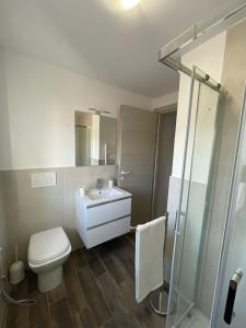 a bathroom with a toilet and a sink and a shower at Terni Urban Nest in Terni
