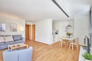 a living room with a couch and a table at BBarcelona Plaça Universitat Flat in Barcelona