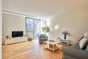 a living room with a couch and a tv at BBarcelona Plaça Universitat Flat in Barcelona