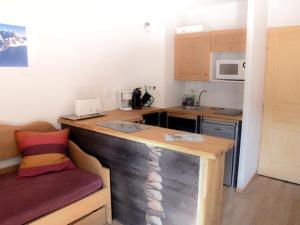 a small kitchen with a wooden counter in a room at Appartement Montgenèvre, 2 pièces, 5 personnes - FR-1-266-86 in Montgenèvre